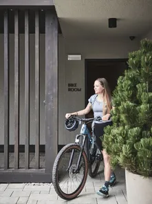 Biker in front of the Bike Hotel AMA Stay in the Dolomites