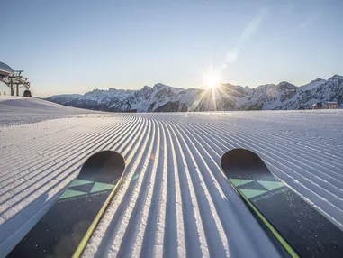 Sunrise on the perfectly groomed ski slopes of the Dolomiti Superski